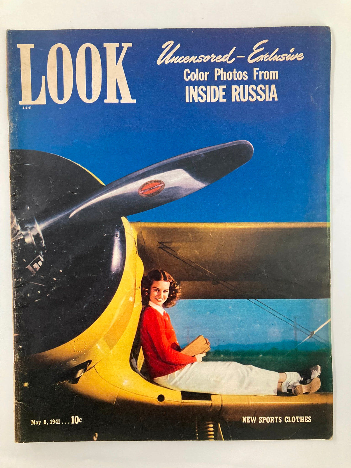 Cover of VTG Look Magazine May 6, 1941 featuring a young woman in a red sweater sitting near a Beechcraft biplane, showcasing vintage fashion and aviation history.