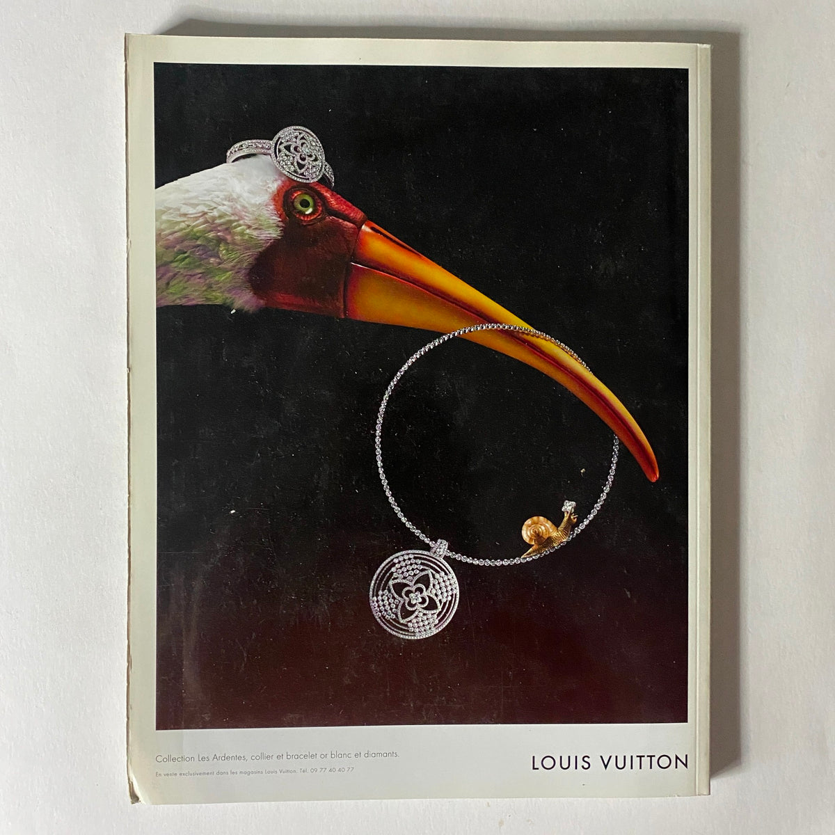 Louis Vuitton advertisement displaying jewelry in Numéro Magazine November 2012 No. 138, featuring a striking bird illustration.