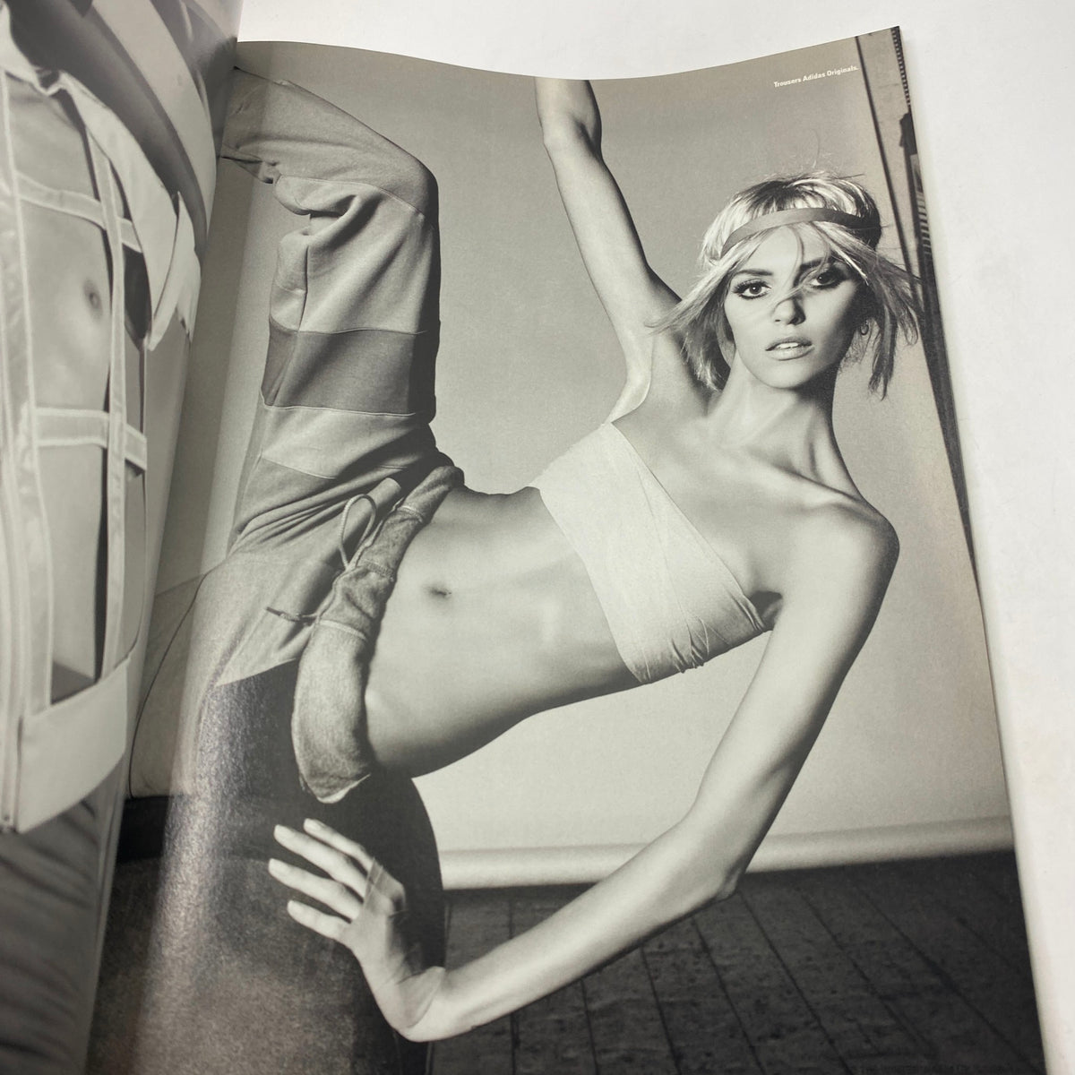 Black and white editorial image from i-D Magazine Winter 2011 No. 316, highlighting a model in an artistic pose, representing the innovative fashion of the season.