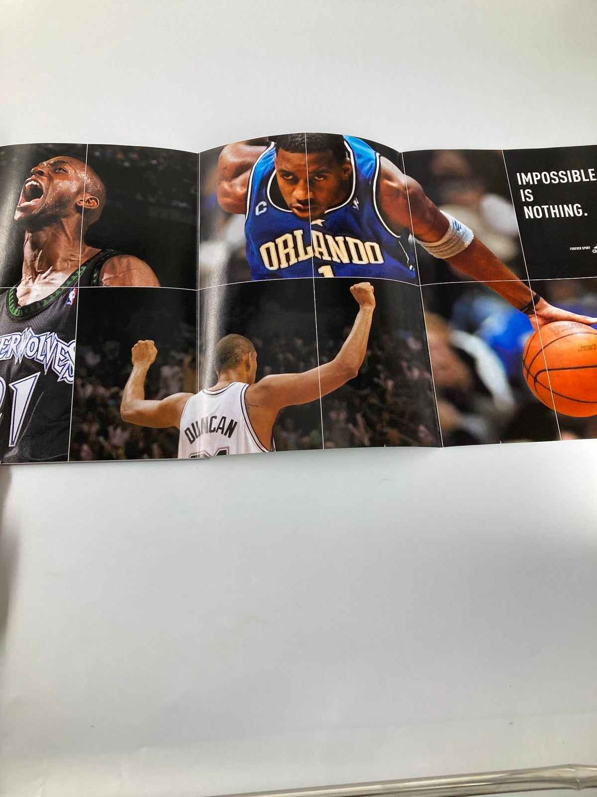 Slam Magazine April 2004 NBA featuring a dynamic fold-out spread with Kevin Garnett and other basketball stars, emphasizing the theme 'IMPOSSIBLE IS NOTHING'.
