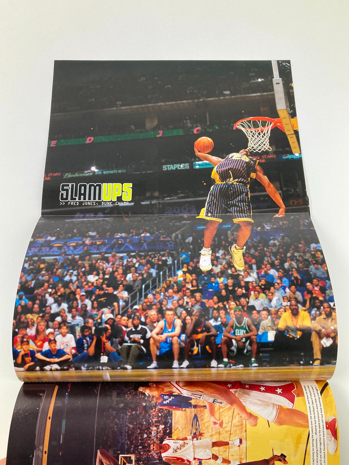 Dynamic action shot of a basketball player dunking from the Slam Magazine May 2004 issue, emphasizing the excitement of NBA gameplay.