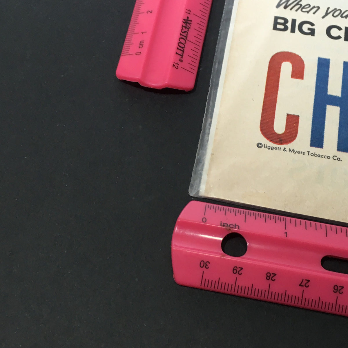 Close-up view of a Vintage 1957 Chesterfield King Size Cigarette Print Ad highlighting the slogan 'BIG CLEAN TASTE OF TOP-TOBACCO', emphasizing its collectible nature and detailed graphics.