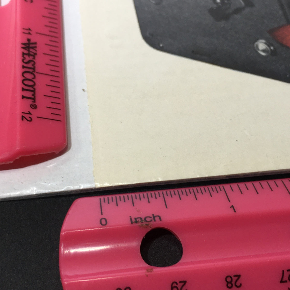 Close-up of a ruler measuring the VTG 1929 Cine-Kodak Eight Model BB for 50-ft reels Print Ad, showcasing vintage filmmaking advertisement details and dimensions.
