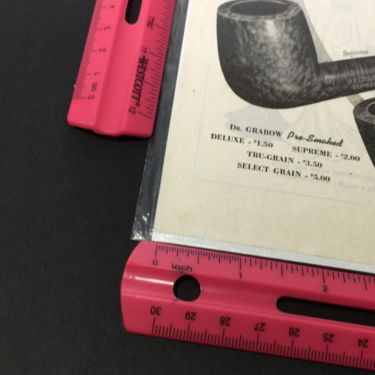 Close-up view of VTG 1969 Linkman by Dr. Gabow Pipe Co. Inc. Tru-Grain Supreme Pipe print ad featuring Dr. Grabow pipes, shown with a ruler for scale.