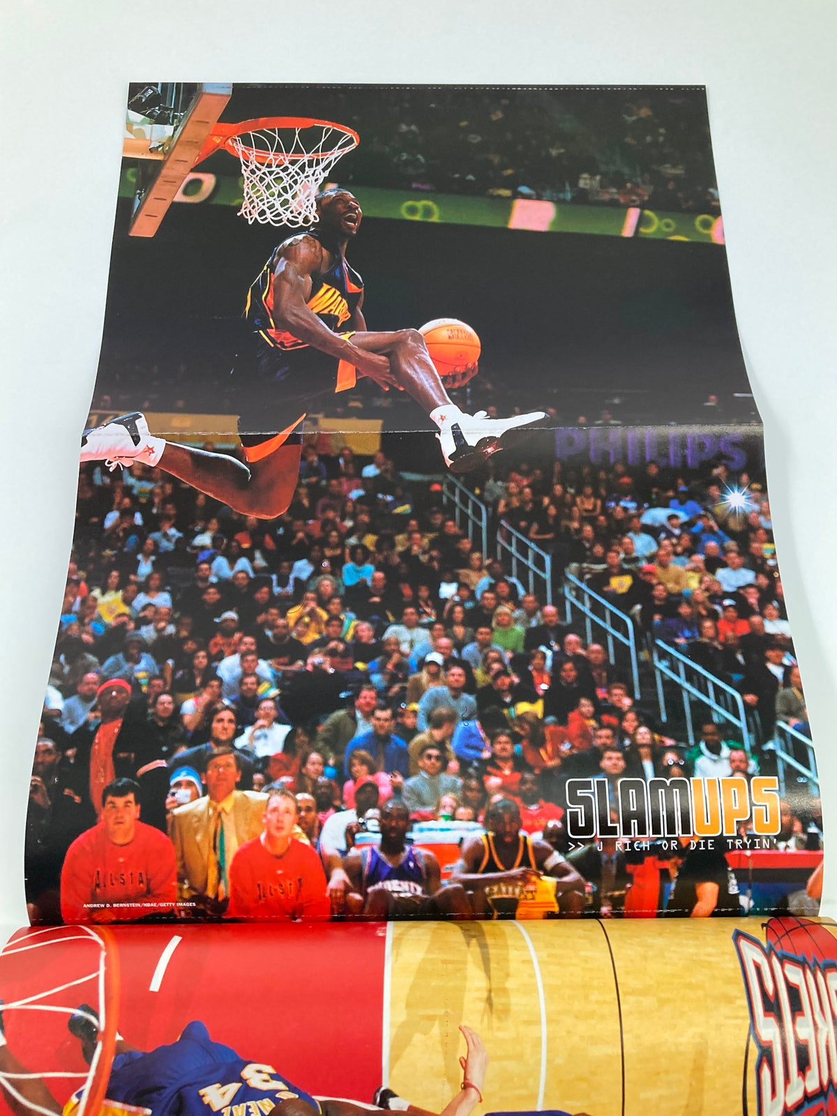 Poster from Slam Magazine May 2003, highlighting an impressive dunk by an NBA player, surrounded by an enthusiastic crowd at a basketball game.