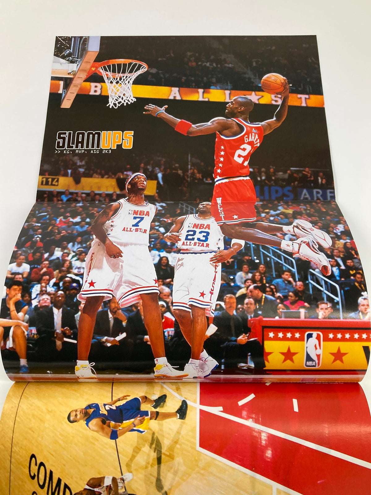 Poster from Slam Magazine May 2003, featuring an NBA player in mid-air during a slam dunk at an All-Star game, with players and fans visible in the background.
