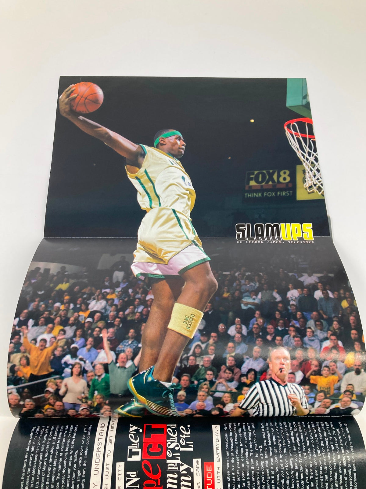 Poster from Slam Magazine April 2003 showing an NBA player performing a dunk, capturing the excitement of basketball culture.