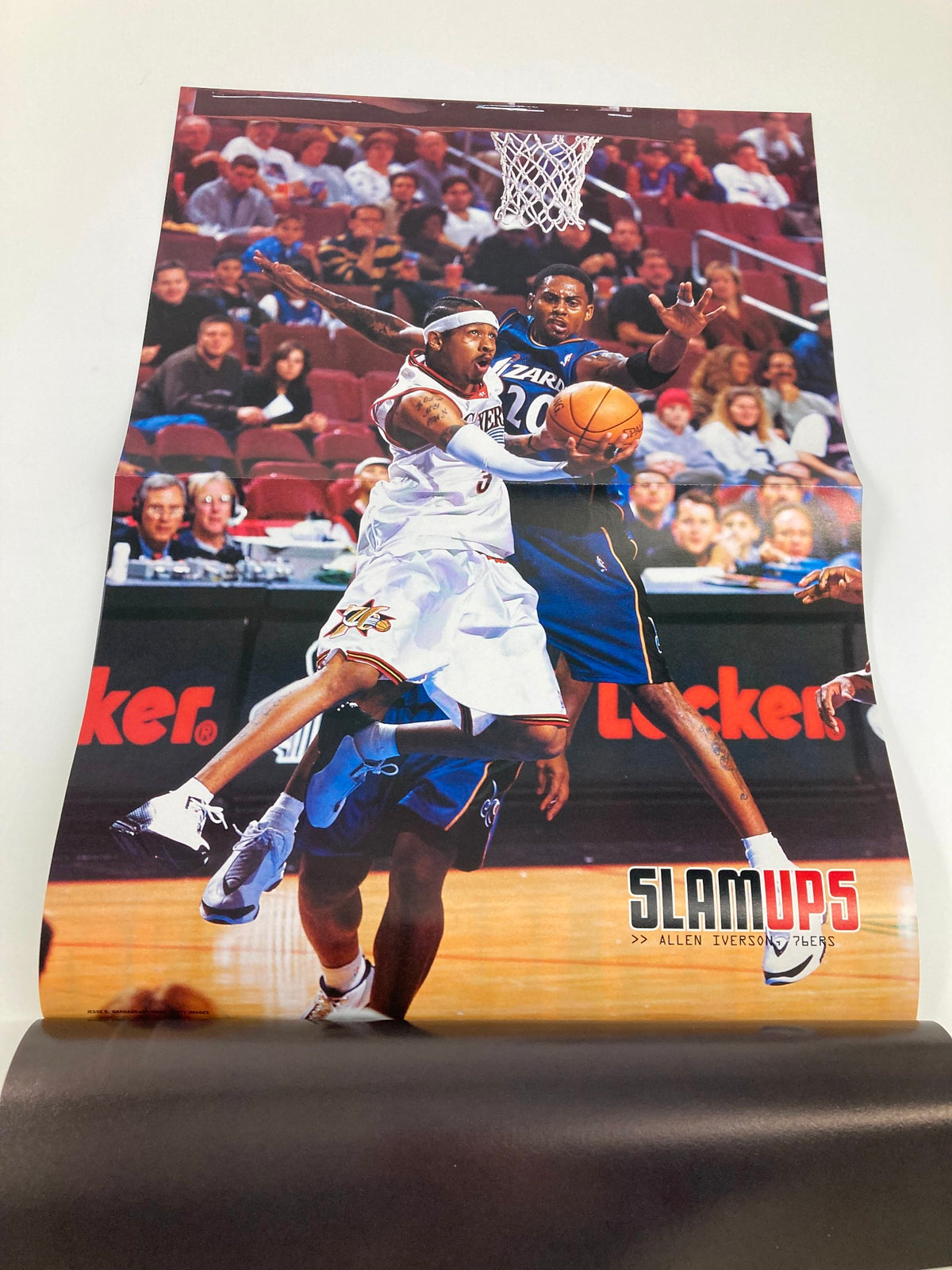 Inside image of Slam Magazine February 2003, featuring a poster of Allen Iverson capturing a dynamic basketball action scene.