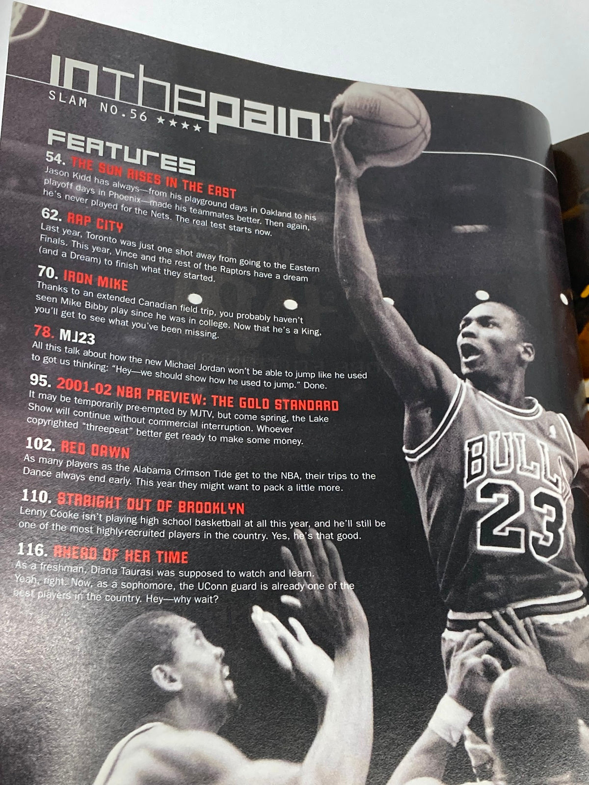 Inside page of Slam Magazine December 2001, highlighting key features about Michael Jordan's return and gameplay, accompanied by a photo of Jordan in action.
