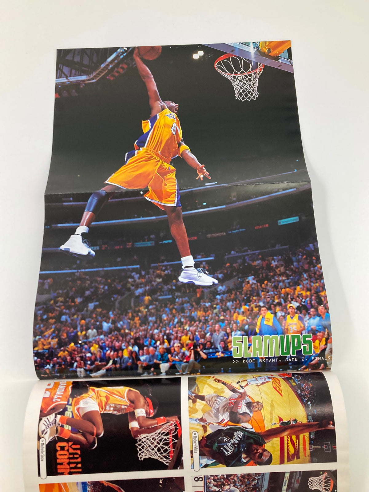 Poster spread from Slam Magazine September 2001 depicting Kobe Bryant making a dynamic dunk during a game, highlighting basketball action and excitement.