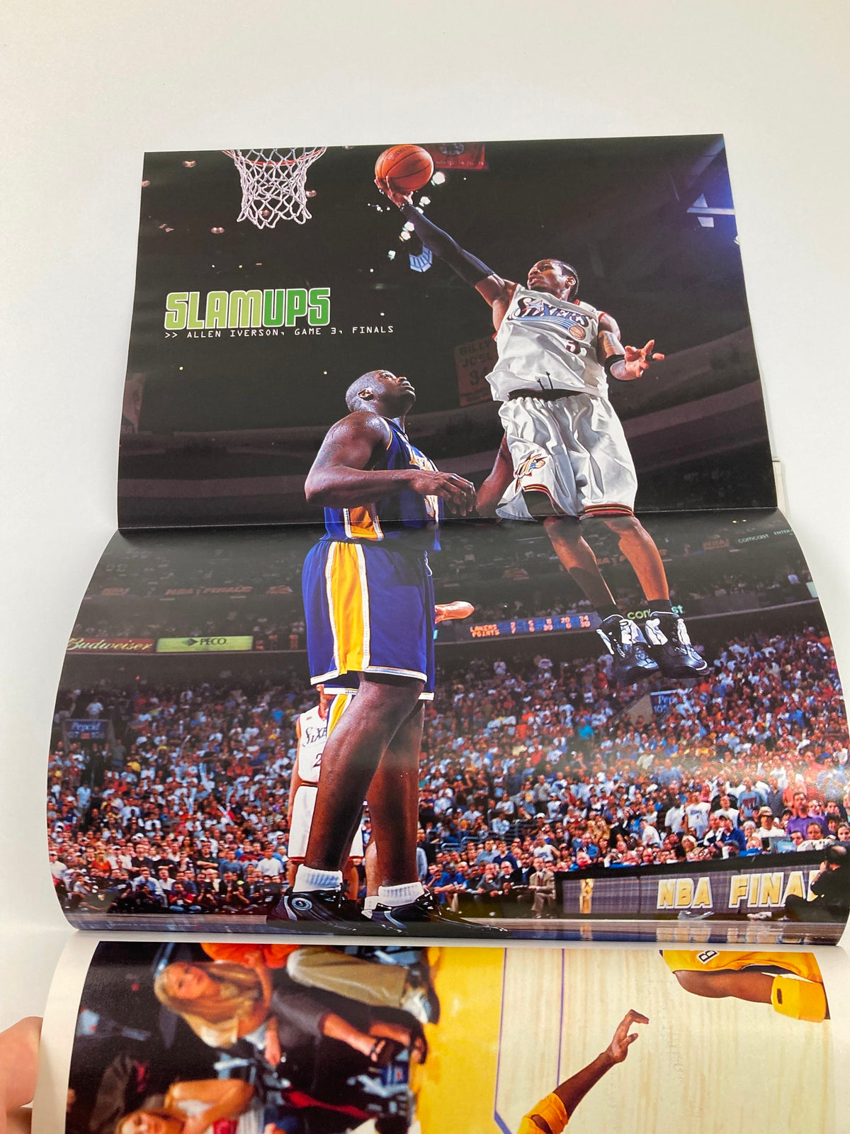 Action shot from the September 2001 Slam Magazine featuring NBA Finals highlights with Shaquille O'Neal and an opposing player. This image captures the excitement of basketball, showcasing dynamic gameplay and the high-energy atmosphere of the game.