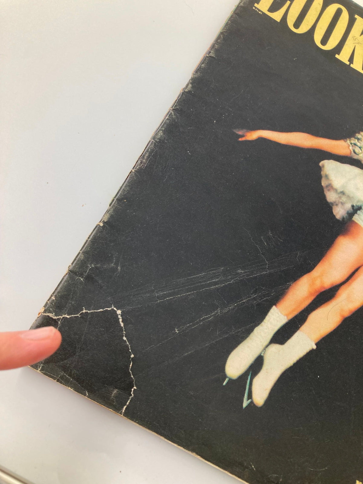 Close-up of the damaged cover of VTG Look Magazine March 11 1941 featuring Dorothy Lewis in 'Ice Frolics' with visible wear and tear.