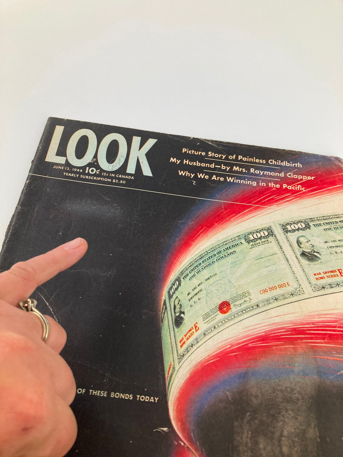 Close-up detail of the cover of VTG Look Magazine June 13, 1944 focusing on the headline 'Buy One of These Bonds Today' with an artistic display of money.