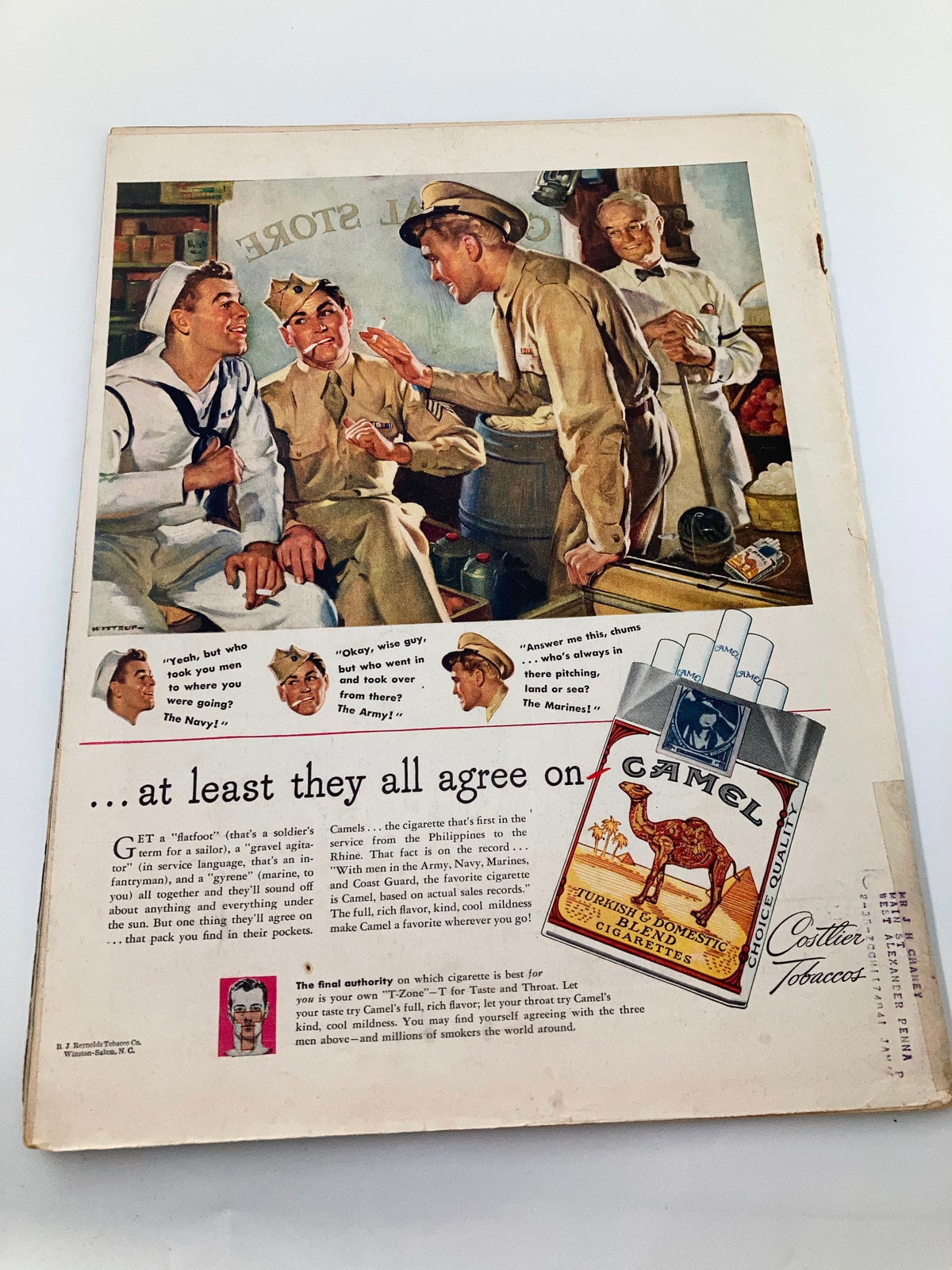 Vintage image from VTG Life Magazine January 15, 1945 featuring soldiers enjoying a humorous moment at a general store with a Camel cigarette advertisement.