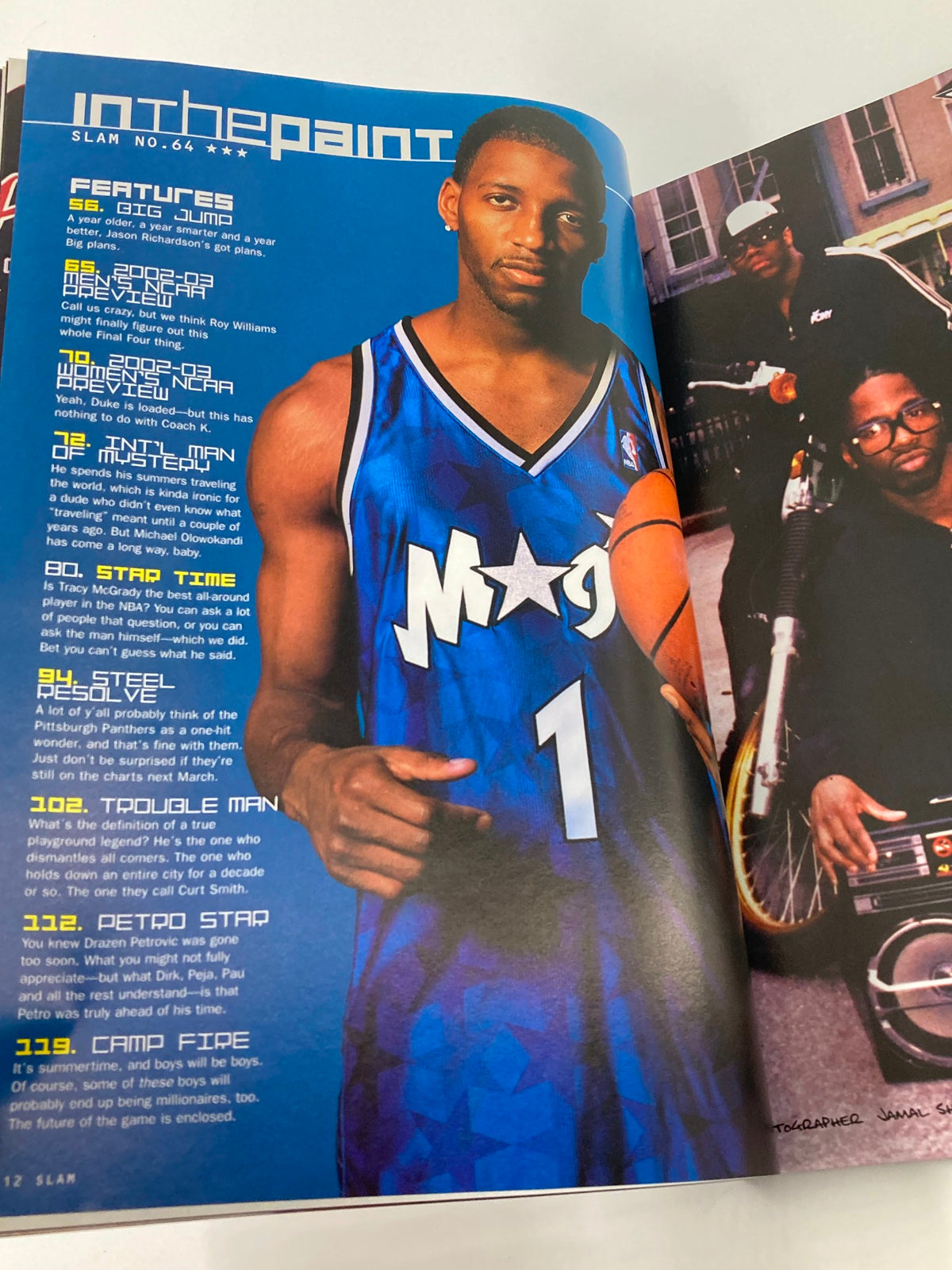 Slam Magazine November 2002 featuring Orlando Magic superstar Tracy McGrady in a blue jersey, showcasing the basketball player's dynamic pose with a basketball.