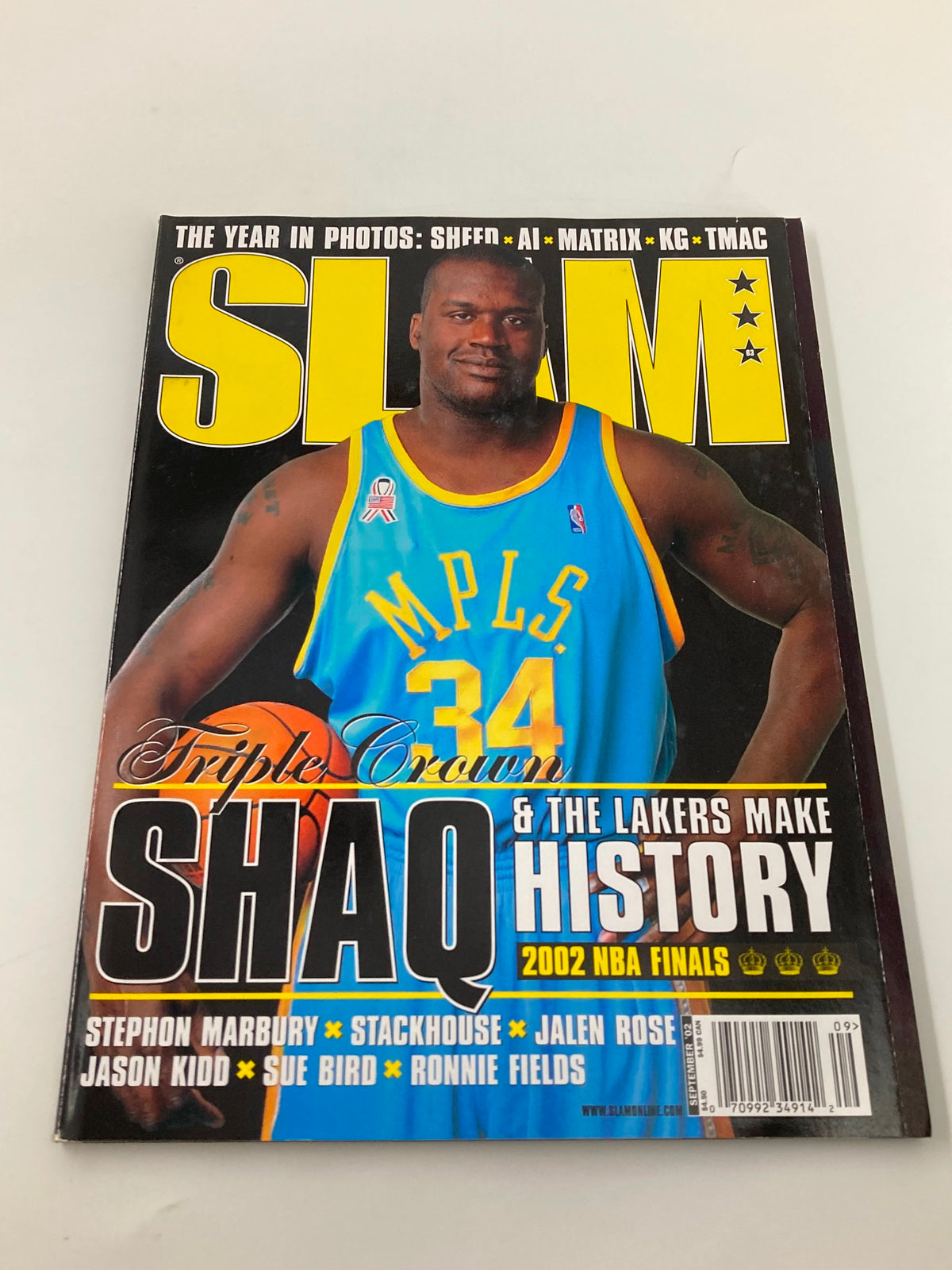Slam Magazine September 2002 cover showing Shaquille O'Neal wearing a blue jersey, emphasizing his legacy with the Lakers during the 2002 NBA Finals.