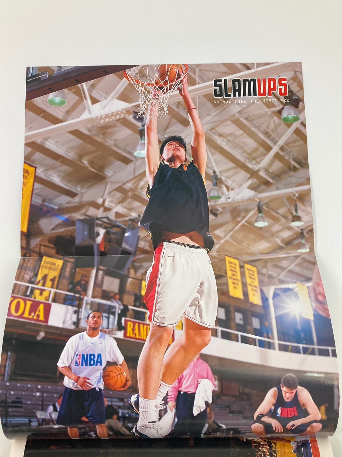 Slam Magazine September 2002 cover featuring Shaquille O'Neal, showcasing a vibrant basketball scene with players and Shaquille O'Neal during a dynamic gameplay moment.