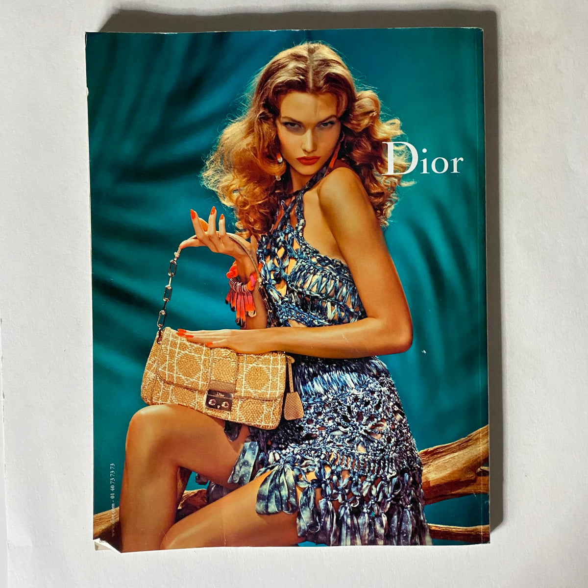 Cover image of Numéro Magazine April 2011 #122 showcasing a model styled in Dior attire with glamorous accessories, capturing the essence of contemporary fashion.