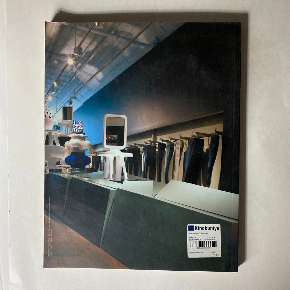 Back cover of IdN Magazine 2008/2009 Vol 15 No. 6 displaying a sleek retail space with contemporary furniture and a minimalist aesthetic, showcasing design trends in the retail revolution.