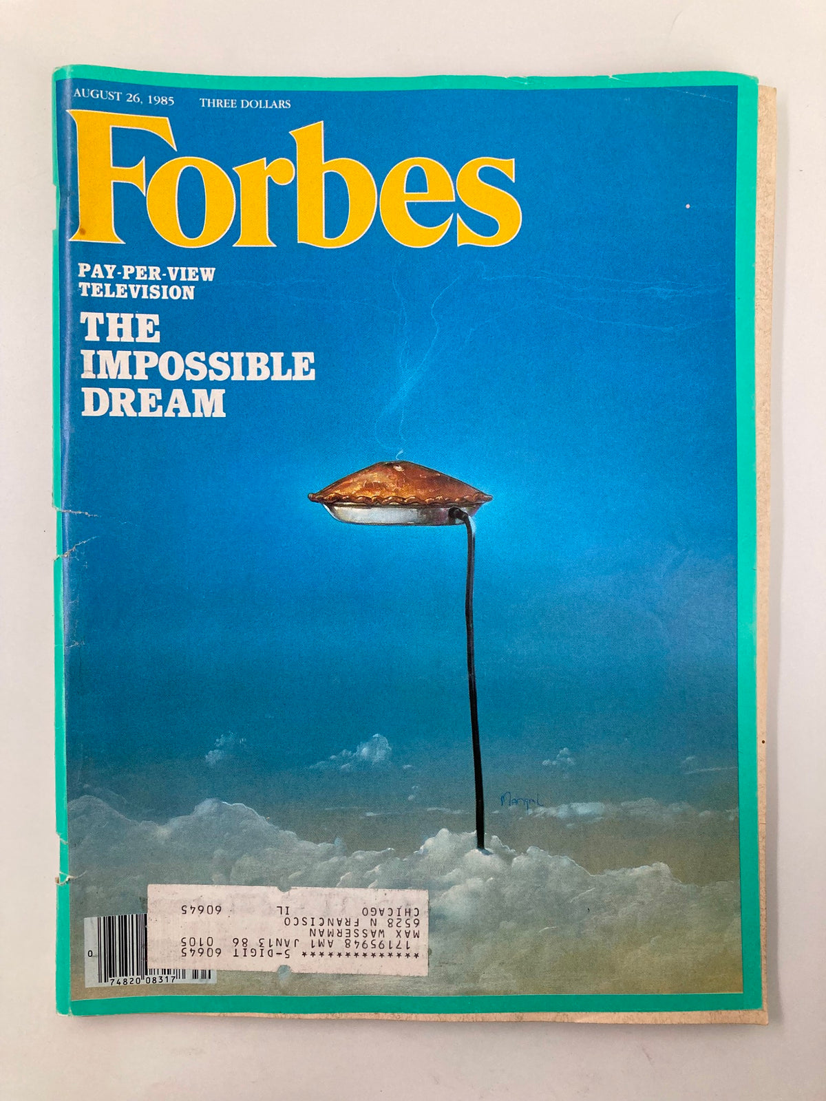 Cover of VTG Forbes Magazine, August 26, 1985 featuring the article 'Pay-Per-View Television: The Impossible Dream'. The cover illustration depicts a surreal image of a pie hovering above the clouds.