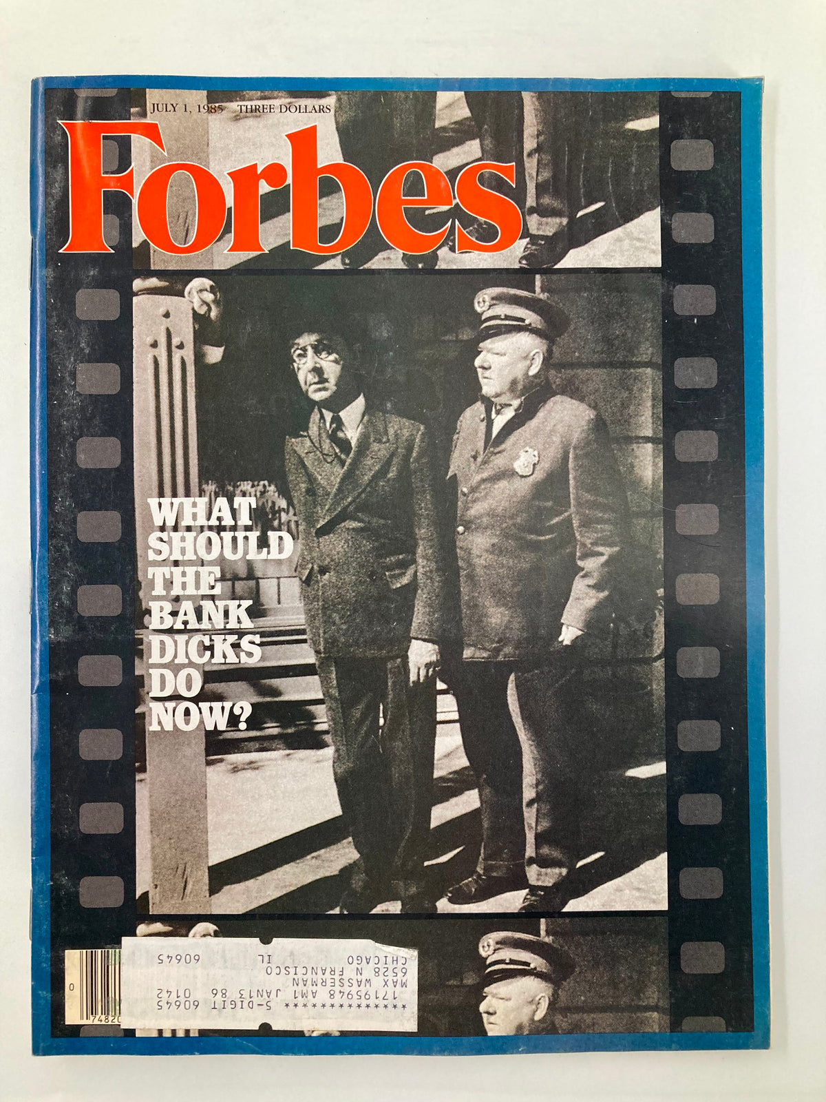 Forbes Magazine cover from July 1, 1985, featuring the article 'What Should The Bank Dicks Do Now?' with a striking black and white image of figures in discussion.