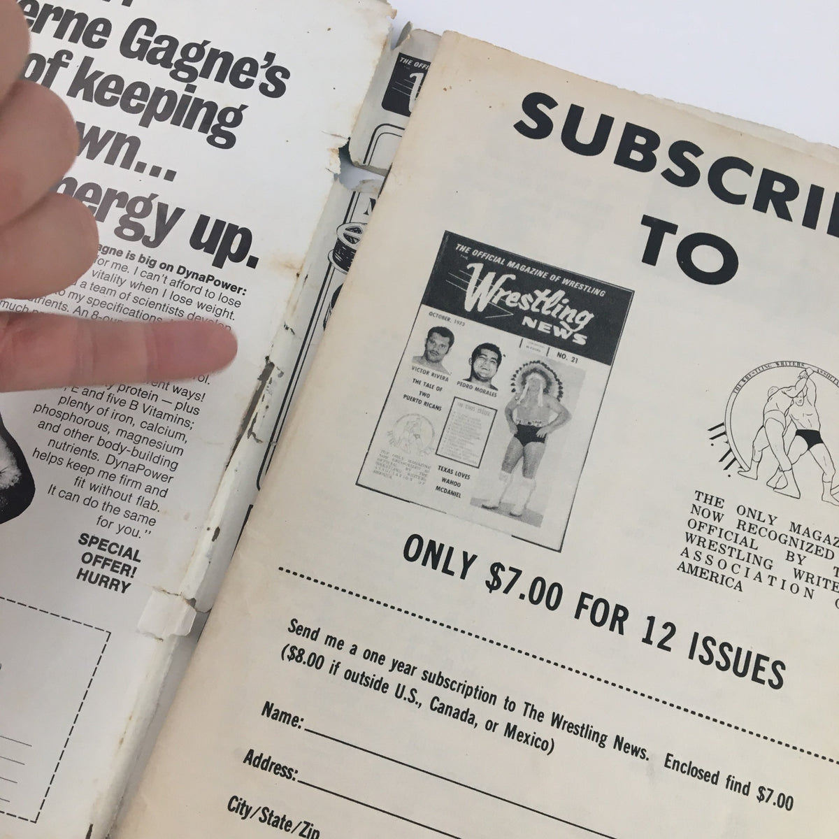 Inside page of Wrestling News Magazine January 1974 showing a subscription advertisement with finger pointing at text, highlighting the magazine's collectible value.