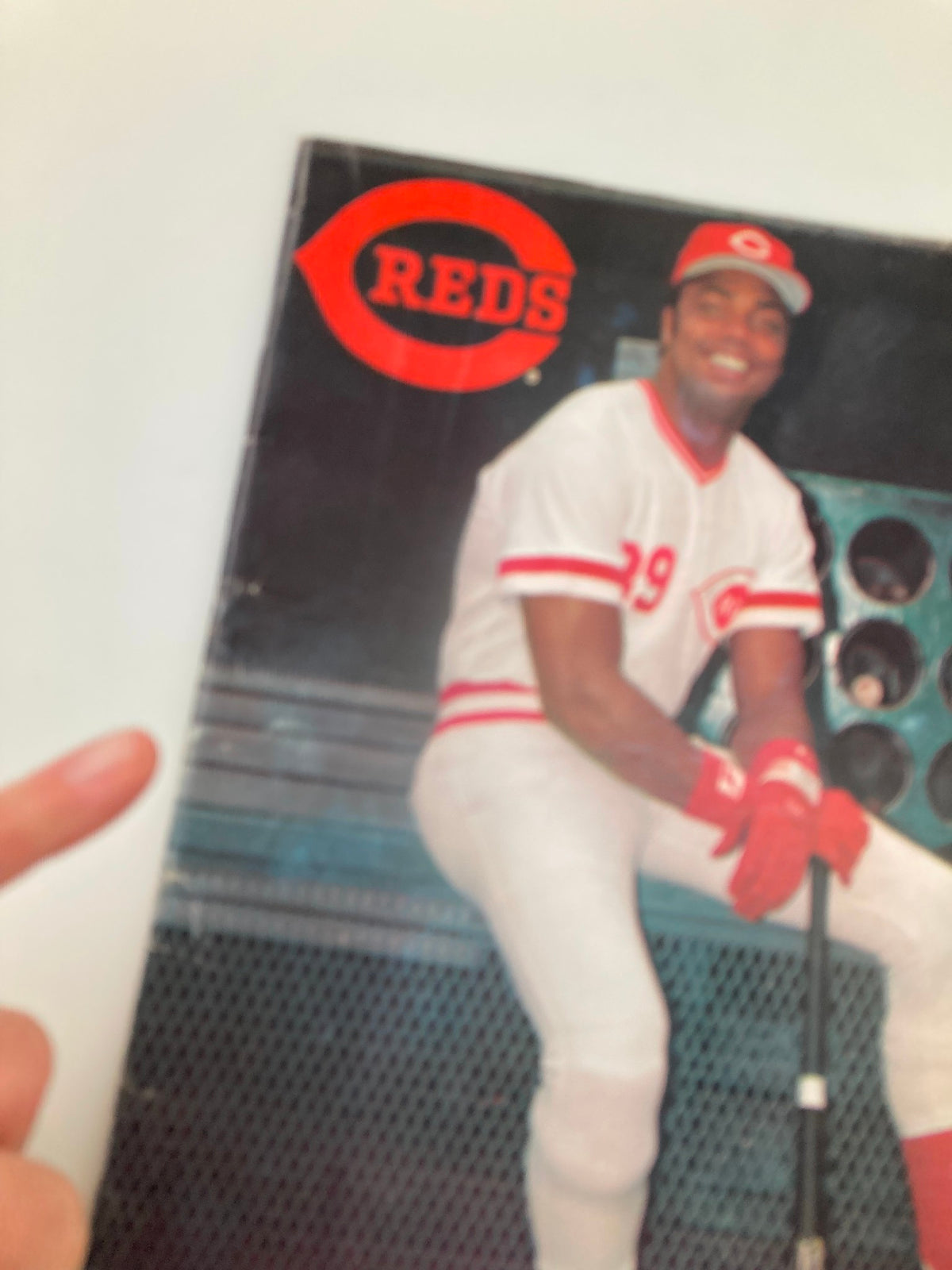 1985 MLB Cincinnati Reds Official Scorebook Program featuring a smiling player in a Cincinnati Reds uniform, showcasing the iconic team logo.