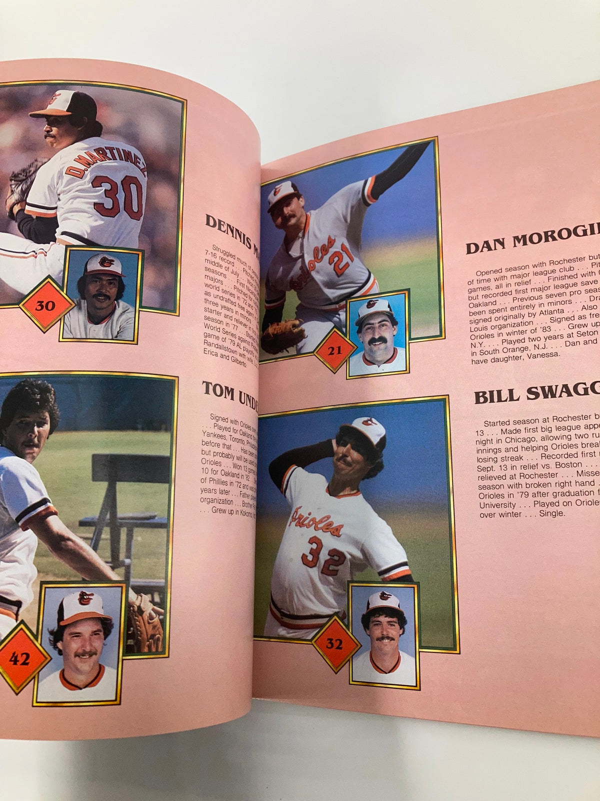 Interior page of the 1983 MLB Baltimore Orioles World Champions 30th Anniversary Official Yearbook showcasing player profiles, including Dennis Martinez and Dan Morogin, with highlighted achievements from the 1983 season.
