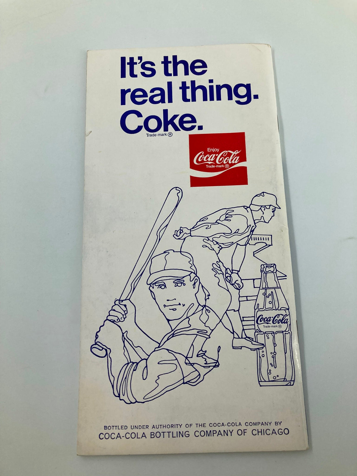 Back cover of the 1973 MLB Chicago Cubs Official Roster Book advertising Coca-Cola, featuring an illustration of a baseball player and promotional text.