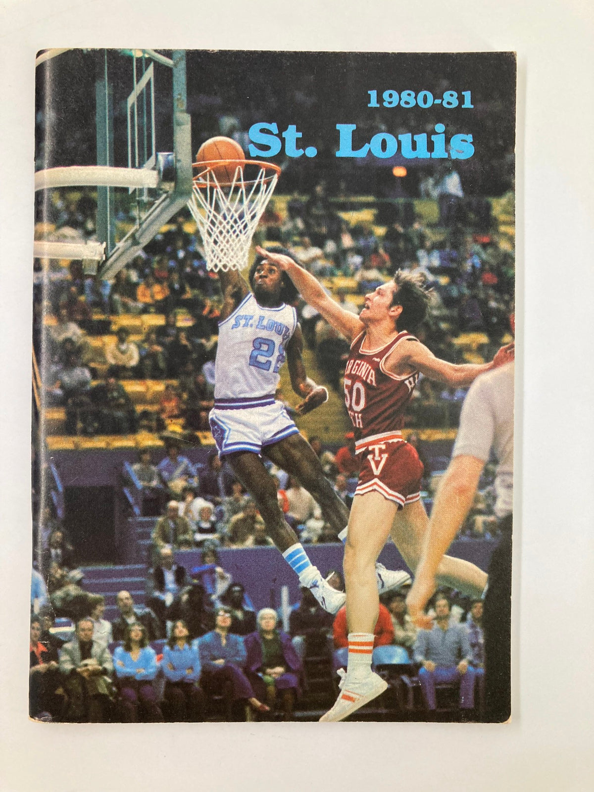 1980-1981 NCAA Saint Louis University Billikens Basketball Press Guide featuring an action shot of a player attempting to score a basket during a game.