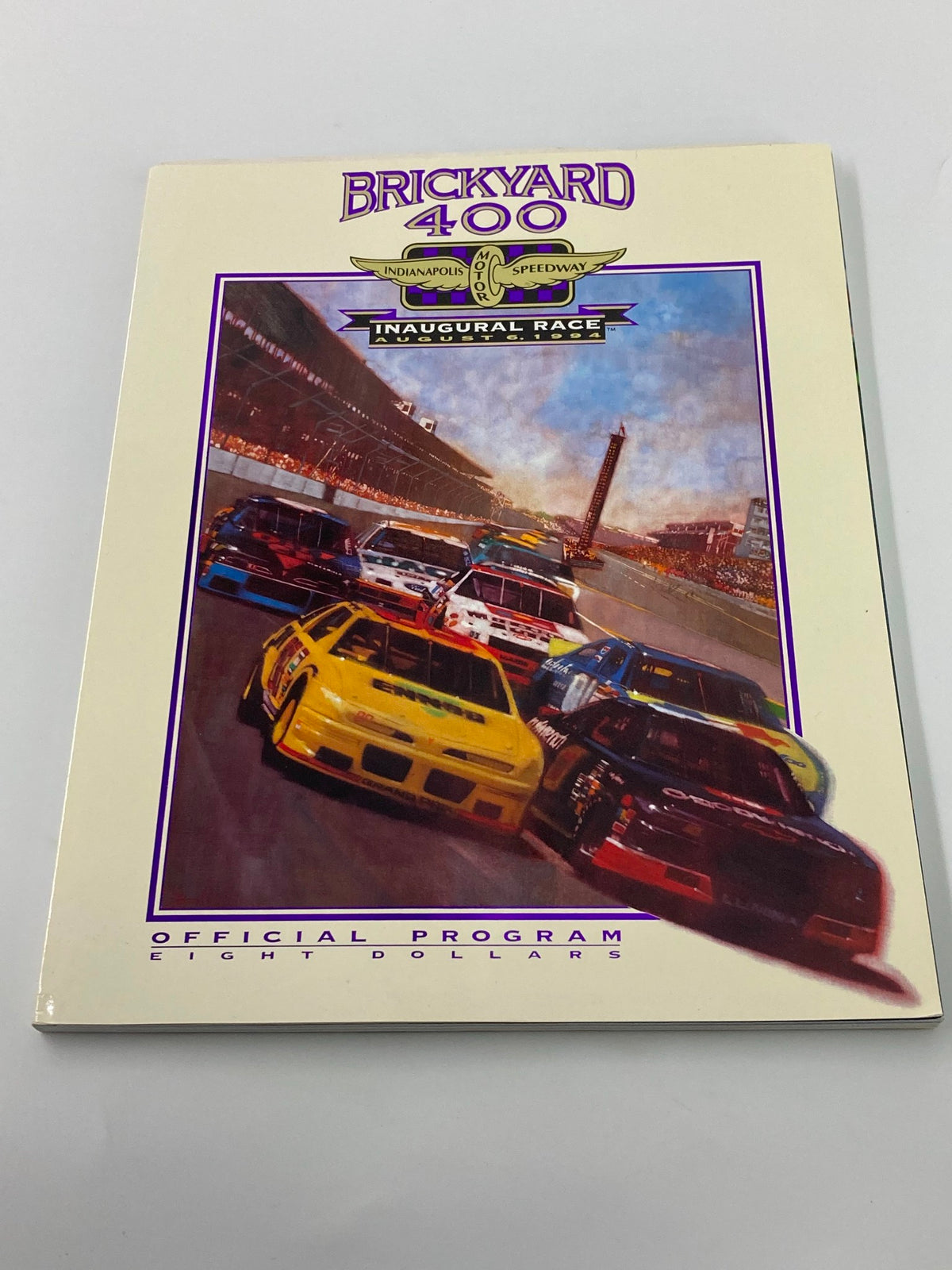 Front cover of the August 6 1994 Brickyard 400 Indianapolis Motor Speedway Official Program showcasing the inaugural race with vibrant racing car artwork.