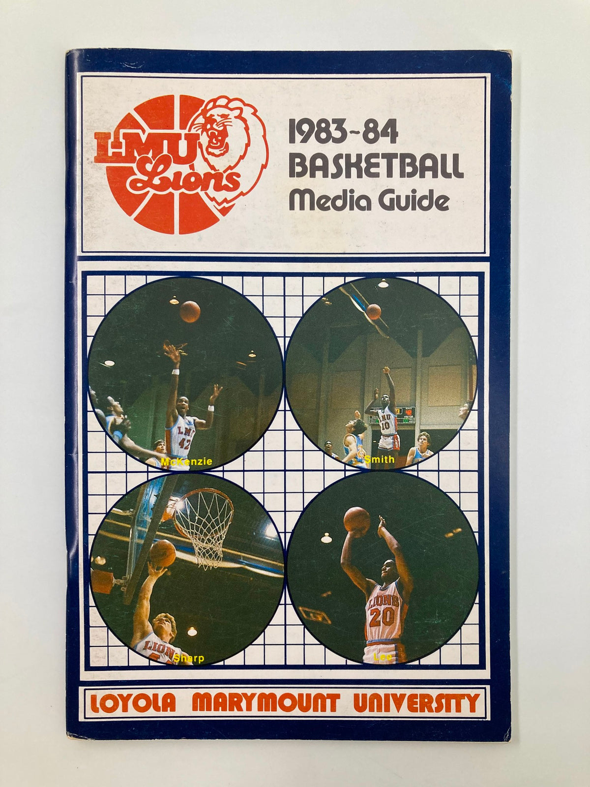 1983-84 NCAA Loyola Marymount Lions Basketball Media Guide featuring a cover design with the Loyola Marymount Lions logo and basketball action shots of players, showcasing the team's spirit and athleticism.