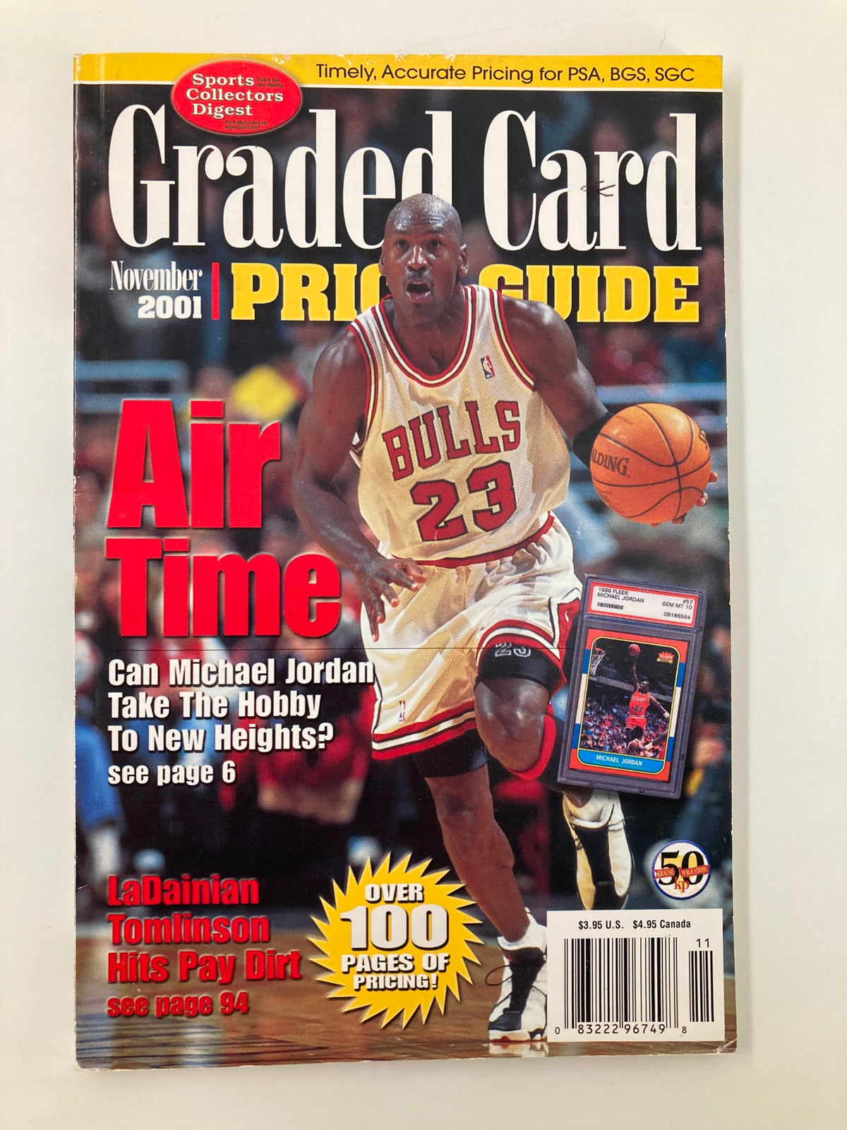 Graded Card Price Guide November 2001 featuring NBA star Michael Jordan on the cover, showcasing a basketball player in action while promoting card collecting and pricing insights.