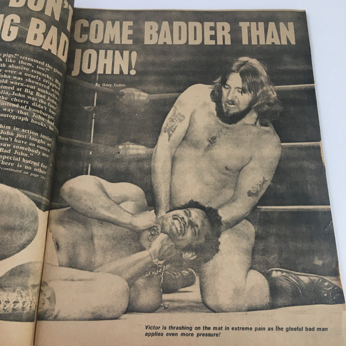 Image from Wrestling Guide October 1974, illustrating a wrestling match with the headline 'They Don't Come Badder Than Big Bad John!', displaying the intensity of wrestling during this era.