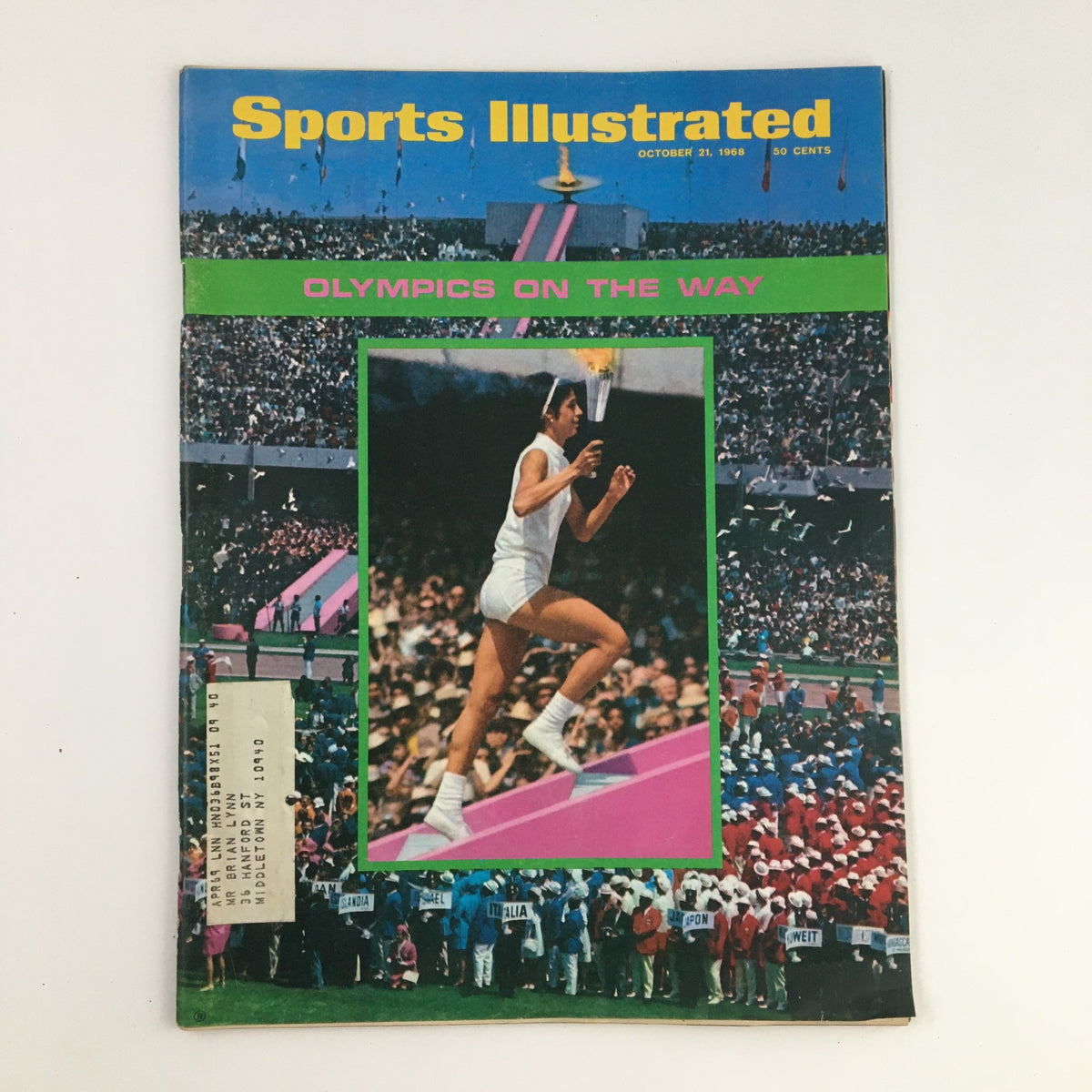 Sports Illustrated Magazine cover from October 21, 1968, featuring the headline 'Olympics on the Way,' showcasing a vibrant image of a female athlete with the Olympic torch amidst a colorful crowd.