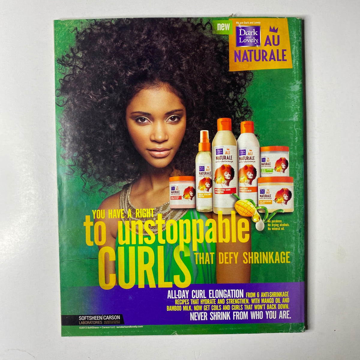 Back cover of Ebony Magazine April 2013 Vol. LXVIII, No. 6, showcasing a beauty advertisement for Dark and Lovely hair products, featuring a model with naturally curly hair.