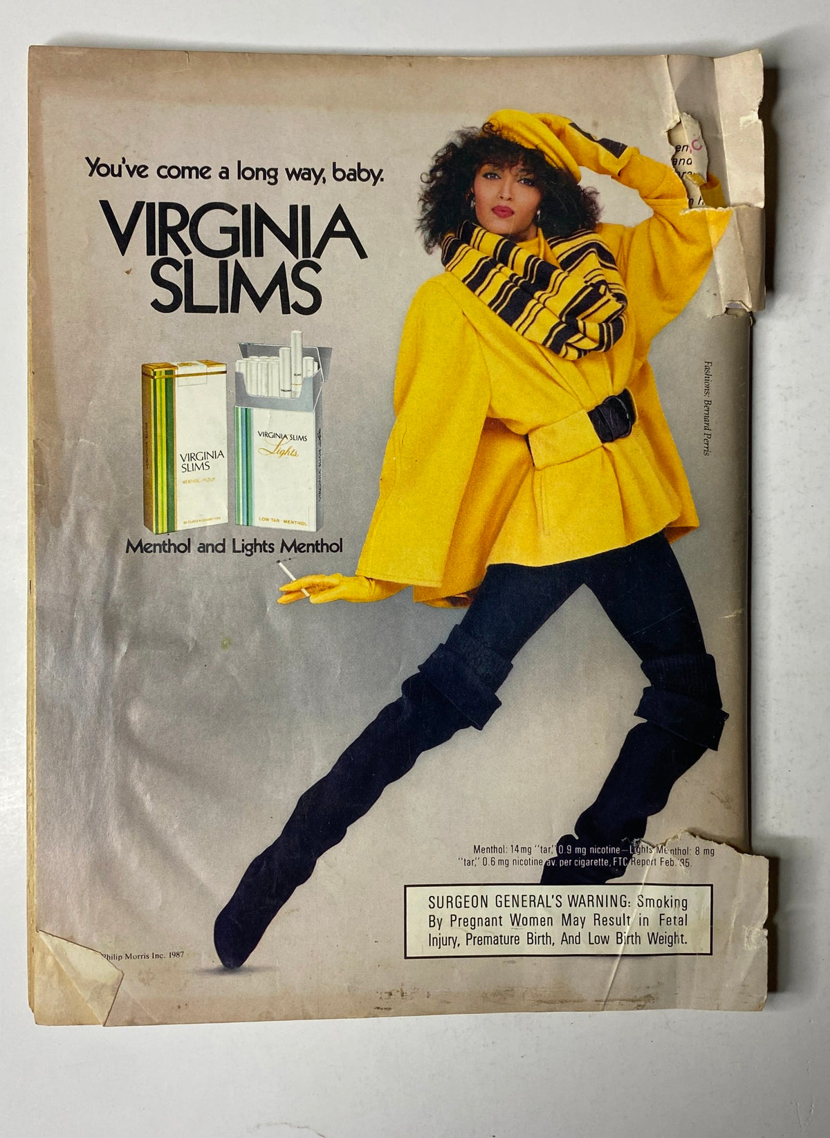 Back cover of Ebony Magazine January 1987 Vol 42 No. 3 showcasing a Virginia Slims advertisement with a model in a striking yellow outfit, promoting the brand's menthol cigarettes.
