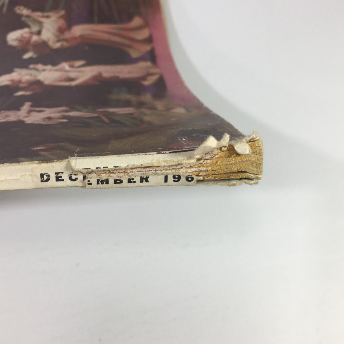 Side view of the VTG High Fidelity Music Magazine December 1964 showing slight wear and tear on the binding.