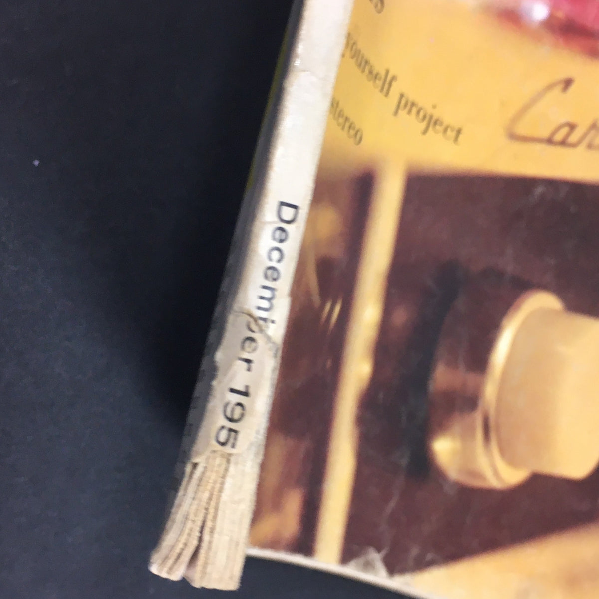 Close-up of the spine of the VTG HiFi Review Magazine December 1959, showcasing the month and year along with vintage aesthetics, perfect for collectors and enthusiasts.