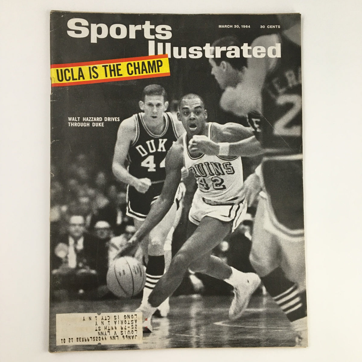 Sports Illustrated Magazine cover from March 30, 1964 featuring Walt Hazzard driving through Duke, showcasing UCLA's championship title with players in action.