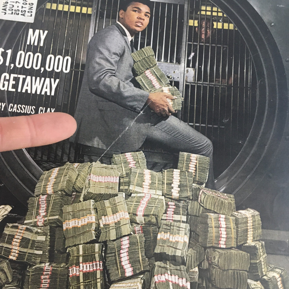 Close-up of the cover of Sports Illustrated Magazine February 24, 1964 showcasing Cassius Clay surrounded by money, highlighting 'My $1,000,000 Getaway'.