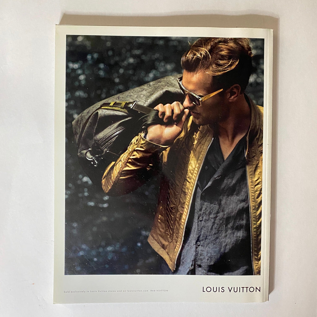 Cover page of VMan Magazine Spring 2011 No. 21 featuring a model in stylish attire with a Louis Vuitton bag, illustrating the blend of luxury fashion and contemporary aesthetics.
