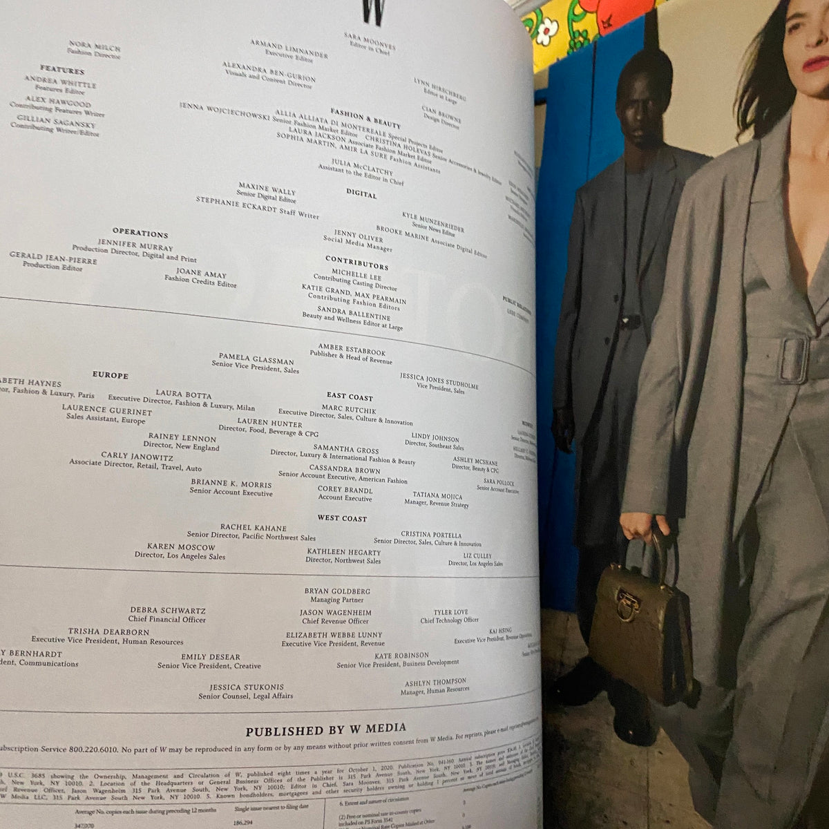 A page from W Magazine 2020 Volume 4 displaying the contributors list alongside a model in a fashionable gray outfit, representing modern fashion narratives.