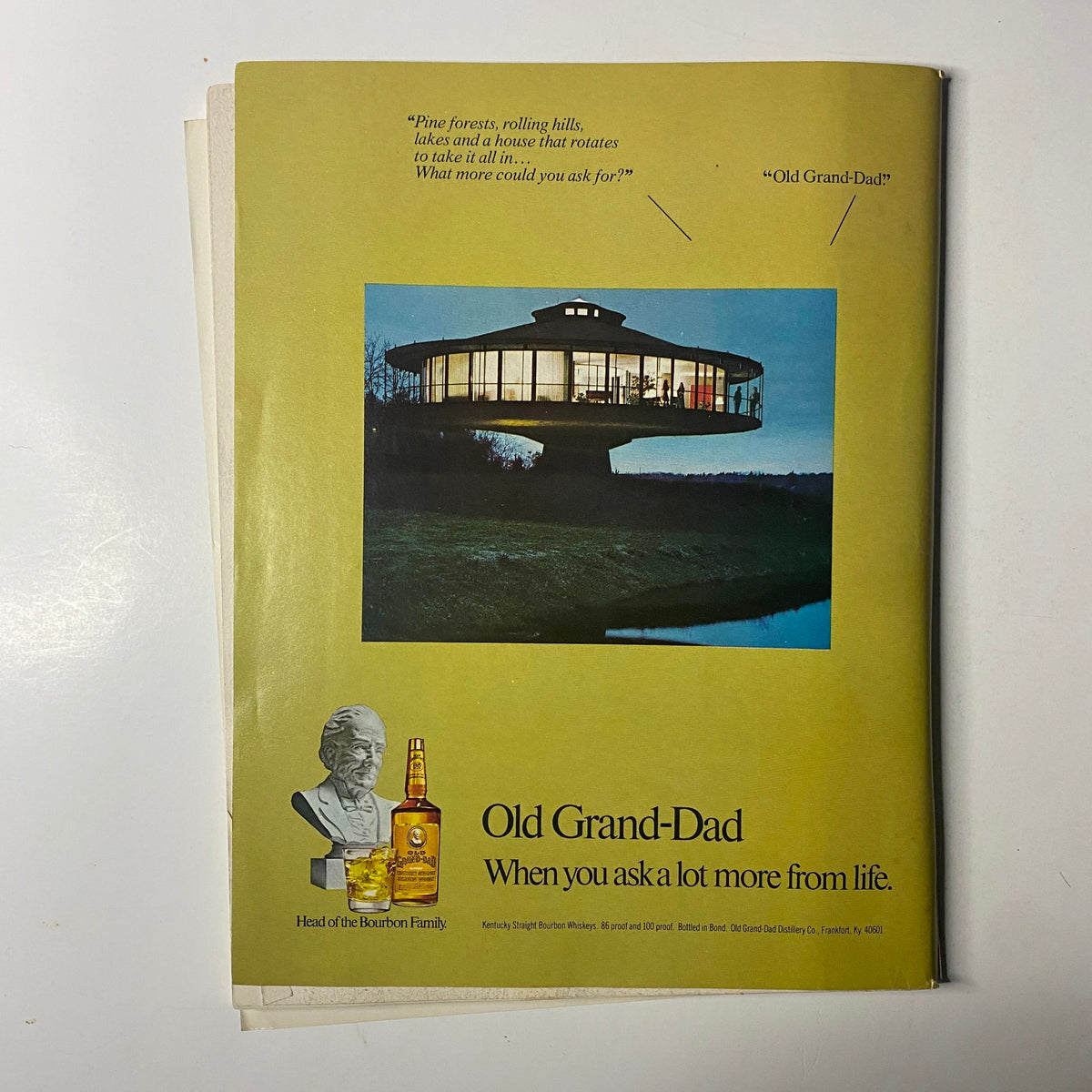 Advertisement page from Chicago Magazine January 1977 featuring Old Grand-Dad bourbon with an artistic image of a futuristic house, emphasizing luxurious living.