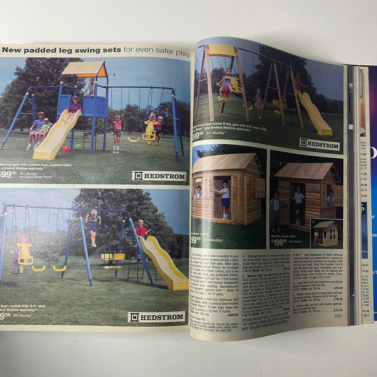 Image from the 1993 Sears Spring Summer Annual Catalog displaying new padded leg swing sets for children, emphasizing safety and outdoor play equipment.