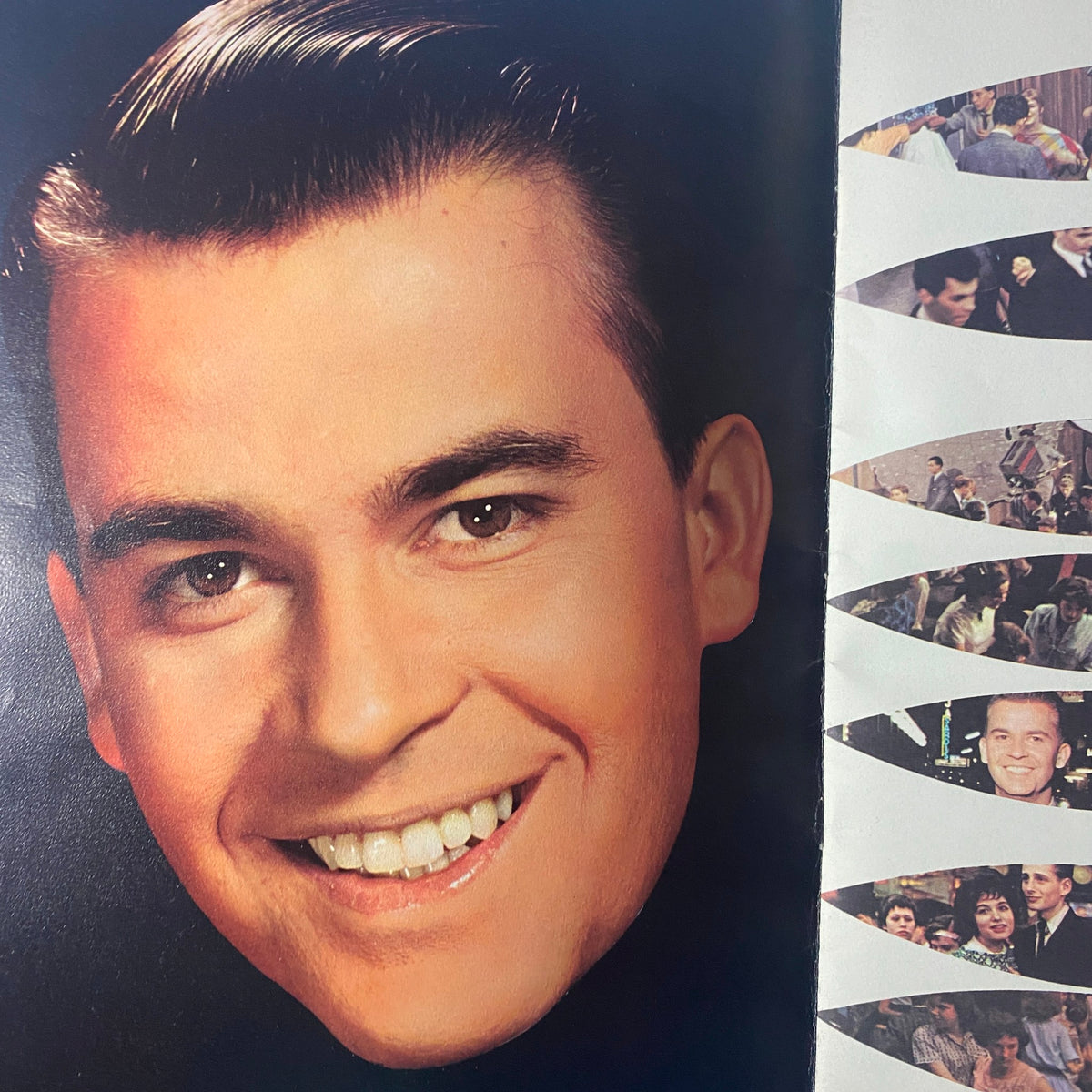 Close-up image of Dick Clark smiling from the 1959 Dick Clark Official American Bandstand Picture Yearbook.