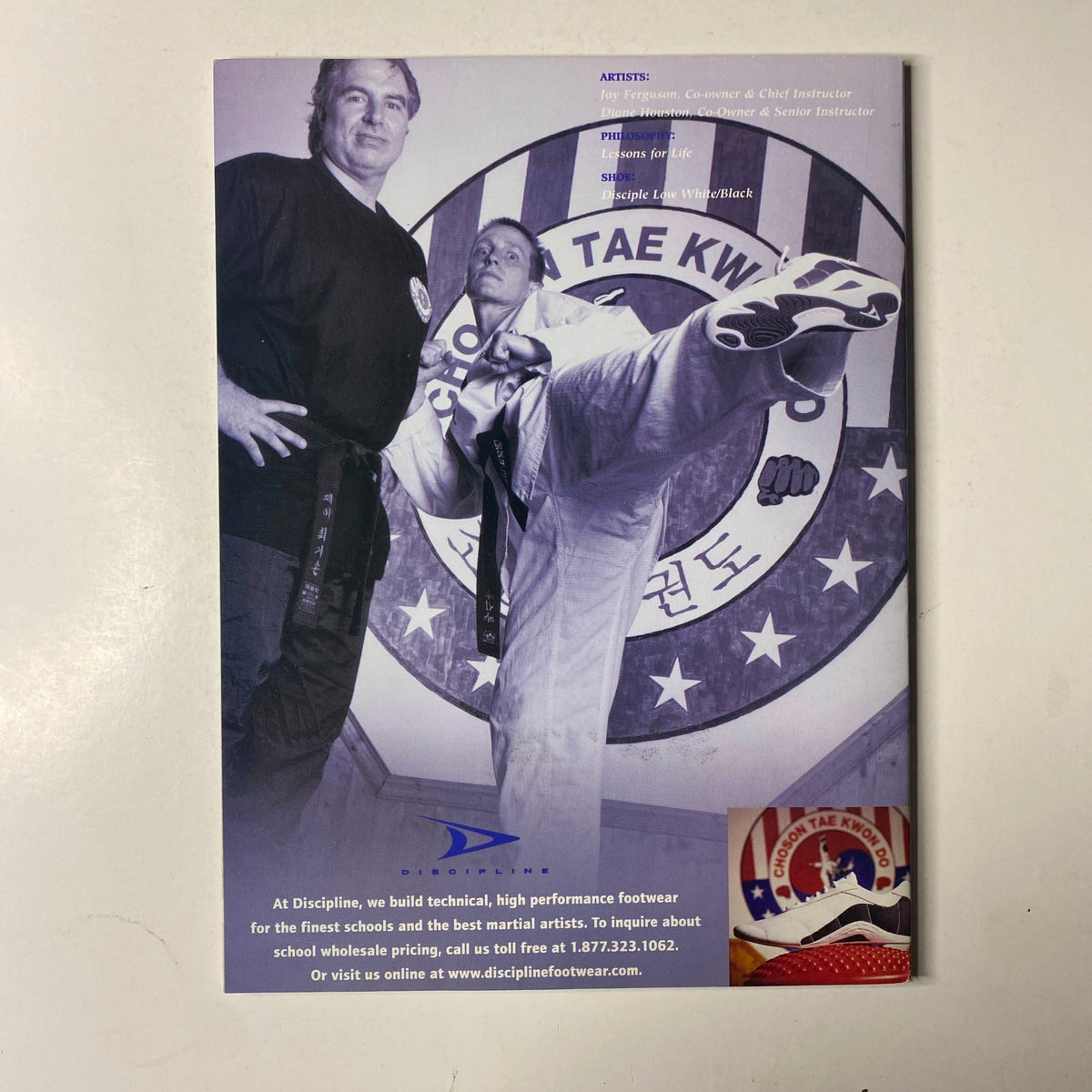 Inside Kung-Fu Magazine April 2003 back cover displays a martial arts promotional image of a kick with the tagline 'Discipline Footwear', highlighting technical footwear for martial artists.