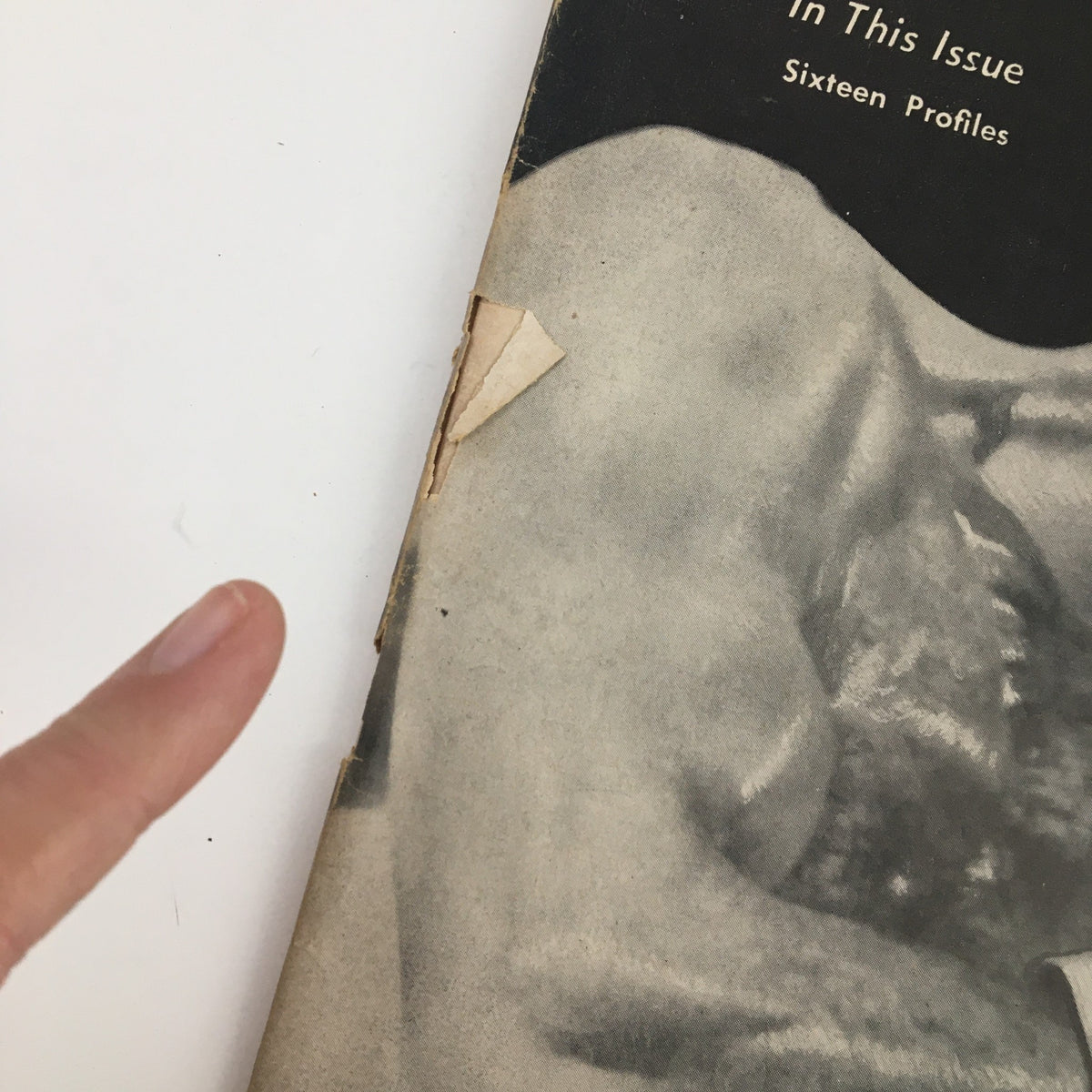 Side view of The Ring Boxing Magazine October 1957 showing aging paper and notable damage, emphasizing its vintage condition.