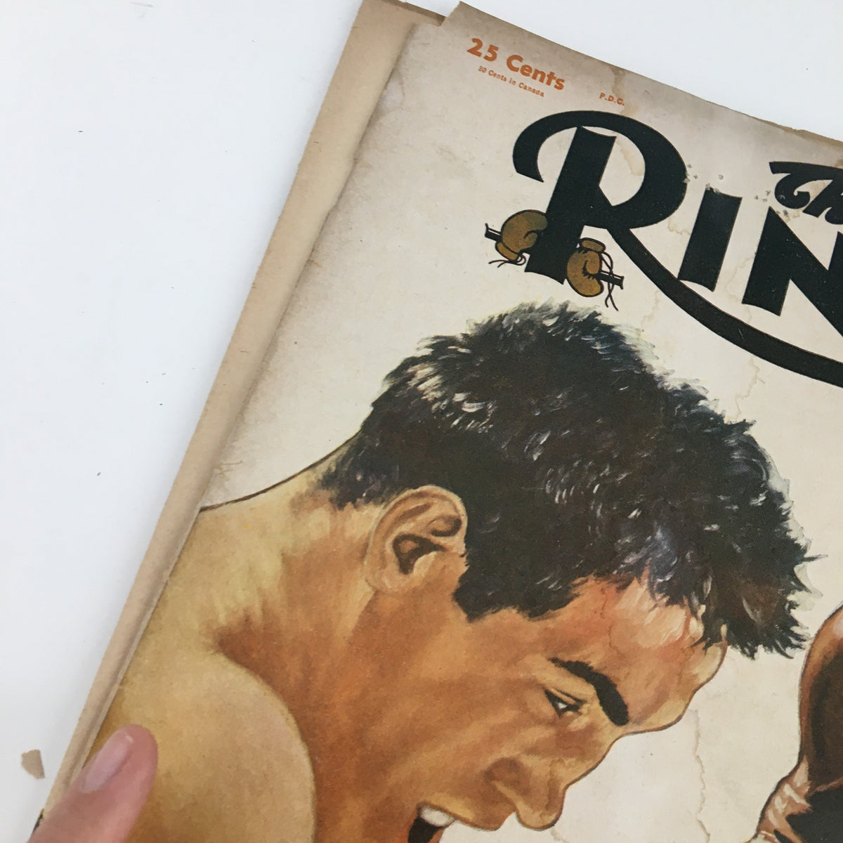Close-up view of The Ring Boxing Magazine June 1954 cover depicting a boxer in action, capturing the vintage essence of boxing culture from the era of Rocky Marciano and Ezzard Charles.