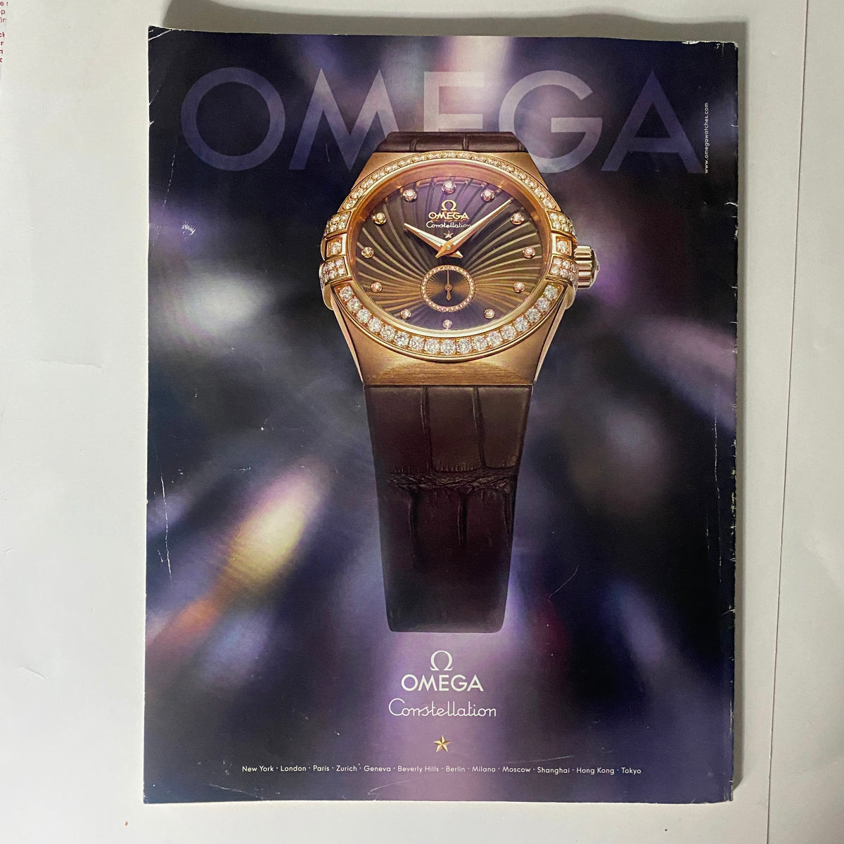 Advertisement page for Omega Constellation watch from February 2010 Interview Magazine, highlighting luxury and sophistication in design.